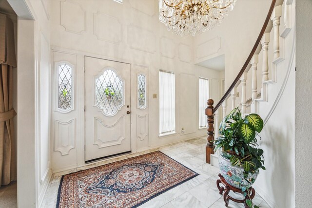 15718 Craighurst Dr, Houston, TX 77059 - entryway featuring a chandelier, stairs, a high ceiling, and marble finish floors