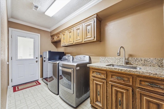 15718 Craighurst Dr, Houston, TX 77059 - laundry area with washer and clothes dryer, cabinet space, brick patterned floors, crown molding, and a textured ceiling