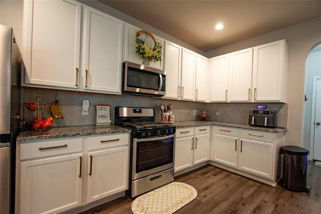22118 Great Royal Ln, Houston, TX 77073 - kitchen with appliances with stainless steel finishes, dark wood finished floors, white cabinets, and recessed lighting
