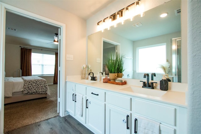 22118 Great Royal Ln, Houston, TX 77073 - ensuite bathroom featuring wood finished floors, double vanity, and a ceiling fan
