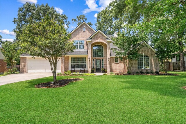 18882 Mystic Pt, Montgomery, TX 77356 - traditional home with driveway, brick siding, and an attached garage