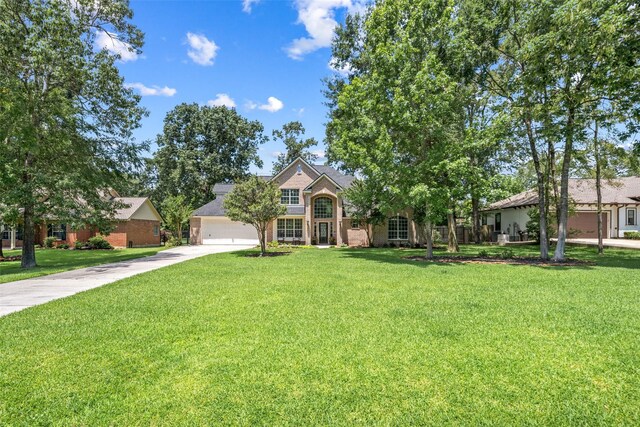 18882 Mystic Pt, Montgomery, TX 77356 - view of front of property with concrete driveway, a front yard, and brick siding