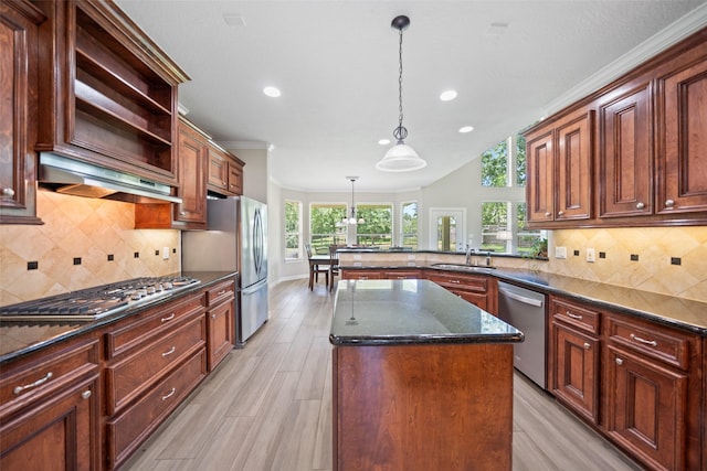18882 Mystic Pt, Montgomery, TX 77356 - kitchen with stainless steel appliances, a peninsula, recessed lighting, light wood finished floors, and tasteful backsplash