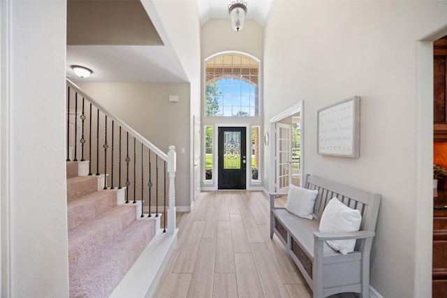 18882 Mystic Pt, Montgomery, TX 77356 - entrance foyer featuring wood finished floors, stairway, and high vaulted ceiling
