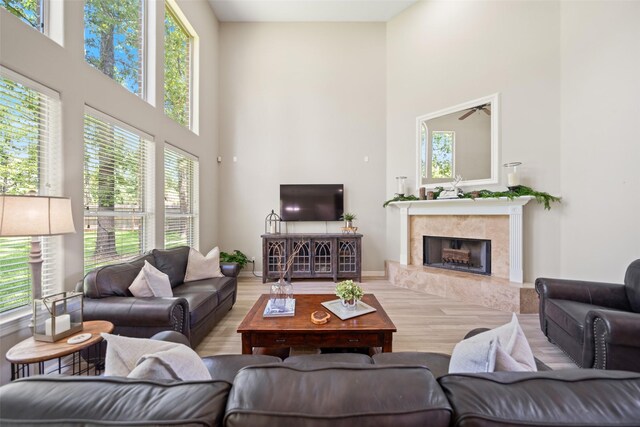 18882 Mystic Pt, Montgomery, TX 77356 - living area featuring a towering ceiling, wood finished floors, and a premium fireplace