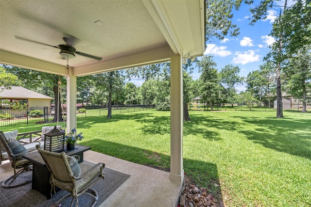 18882 Mystic Pt, Montgomery, TX 77356 - fenced backyard with ceiling fan and a patio area