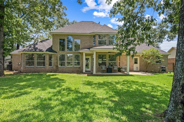 18882 Mystic Pt, Montgomery, TX 77356 - rear view of property featuring a patio area, brick siding, and a shingled roof