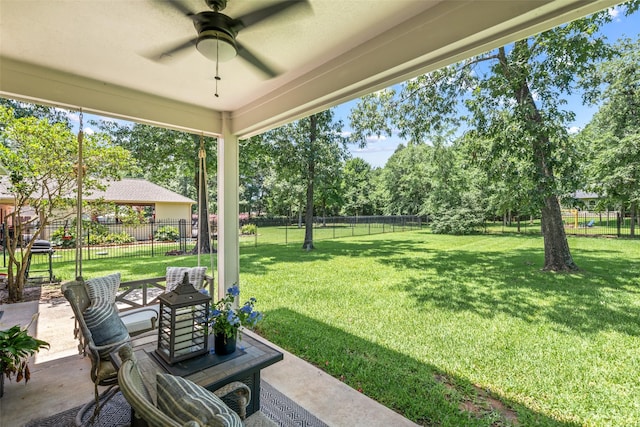 18882 Mystic Pt, Montgomery, TX 77356 - fenced backyard featuring a ceiling fan, a patio, and view of wooded area