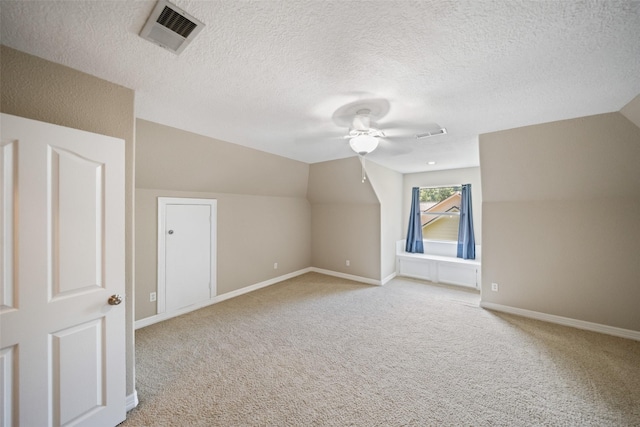 18882 Mystic Pt, Montgomery, TX 77356 - bonus room featuring a ceiling fan, a textured ceiling, vaulted ceiling, and light carpet