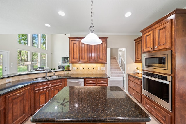 18882 Mystic Pt, Montgomery, TX 77356 - kitchen featuring stainless steel appliances, hanging light fixtures, decorative backsplash, recessed lighting, and dark stone countertops