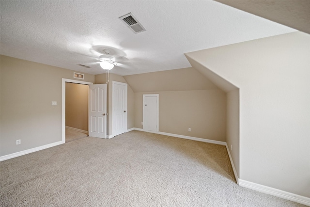 18882 Mystic Pt, Montgomery, TX 77356 - bonus room with light colored carpet, ceiling fan, lofted ceiling, and a textured ceiling