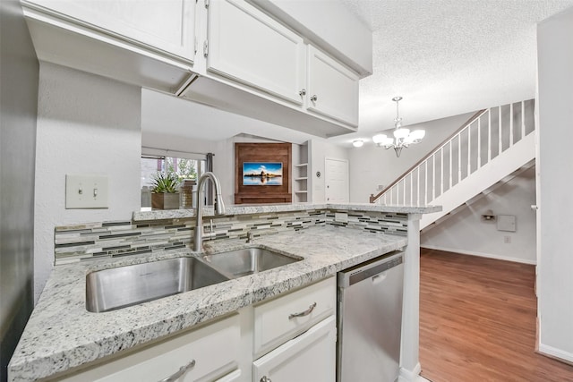 2120 El Paseo St Unit 501, Houston, TX 77054 - kitchen with dishwasher, light wood-type flooring, white cabinets, light stone counters, and hanging light fixtures