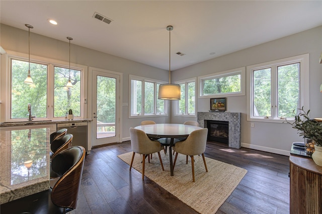 1121 Lashbrook Dr, Houston, TX 77077 - dining room with dark wood finished floors, a fireplace, and recessed lighting