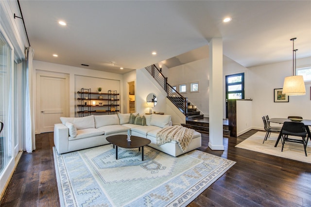 1121 Lashbrook Dr, Houston, TX 77077 - living room with dark wood finished floors, stairway, and recessed lighting