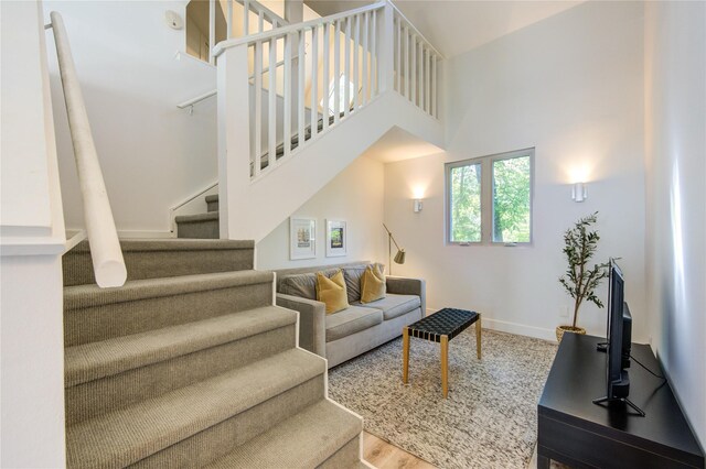 1121 Lashbrook Dr, Houston, TX 77077 - living room with stairs, a towering ceiling, and wood finished floors