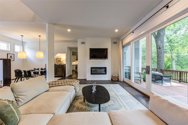 1121 Lashbrook Dr, Houston, TX 77077 - living area with dark wood-style flooring, recessed lighting, and a glass covered fireplace