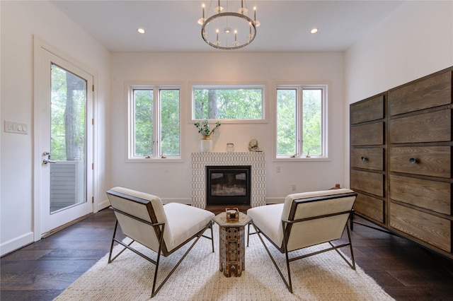 1121 Lashbrook Dr, Houston, TX 77077 - living area with healthy amount of natural light, a chandelier, a glass covered fireplace, dark wood finished floors, and recessed lighting