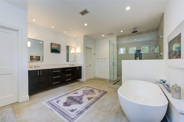 1121 Lashbrook Dr, Houston, TX 77077 - full bath with a stall shower, double vanity, a freestanding tub, recessed lighting, and tile patterned floors