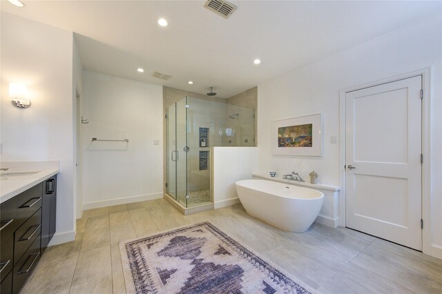 1121 Lashbrook Dr, Houston, TX 77077 - bathroom featuring a stall shower, recessed lighting, a soaking tub, and vanity