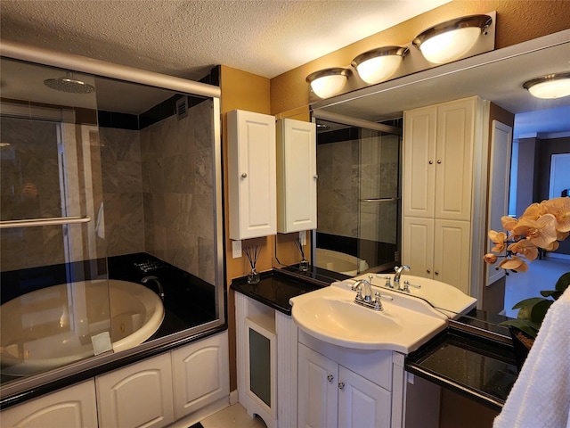 7510 Hornwood Dr Unit 1606, Houston, TX 77036 - bathroom with vanity, a textured ceiling, and a combined bath / shower with jetted tub