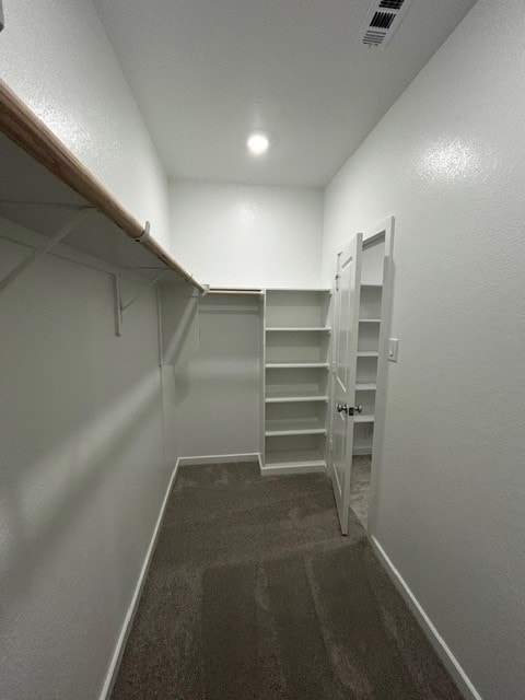 1127 Buffalo Run, Tomball, TX 77375 - walk in closet featuring dark carpet