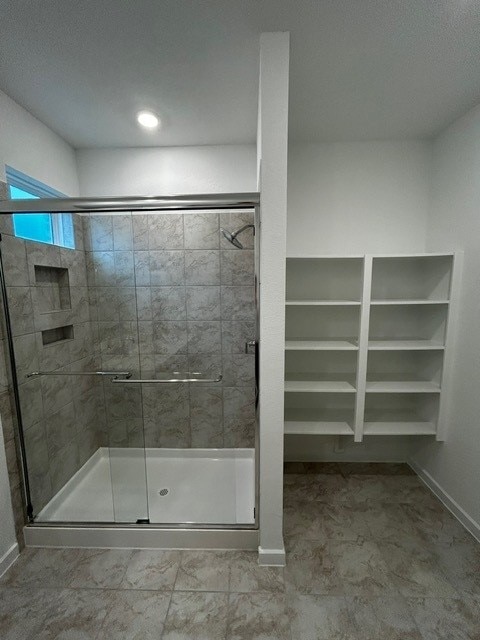 1127 Buffalo Run, Tomball, TX 77375 - bathroom featuring a stall shower and baseboards
