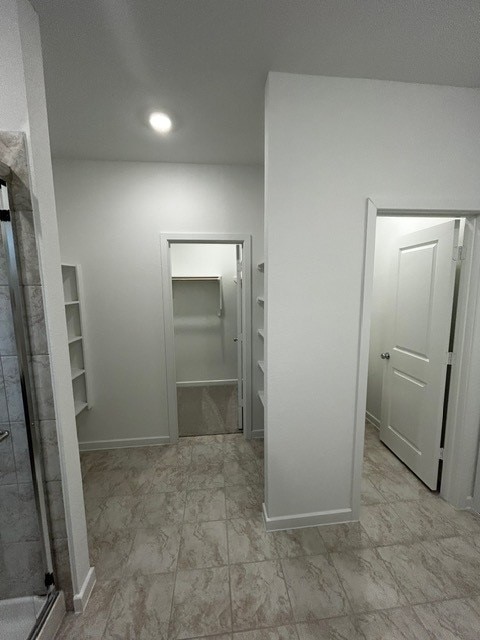 1127 Buffalo Run, Tomball, TX 77375 - hallway featuring baseboards