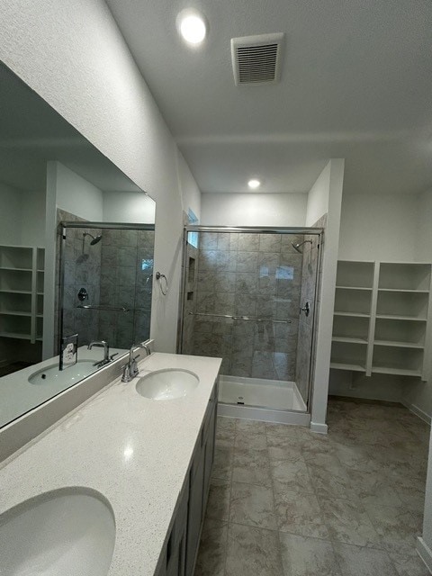 1127 Buffalo Run, Tomball, TX 77375 - full bathroom featuring a walk in closet, a shower stall, double vanity, and recessed lighting