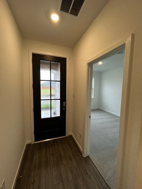 1127 Buffalo Run, Tomball, TX 77375 - doorway featuring baseboards and dark wood-type flooring
