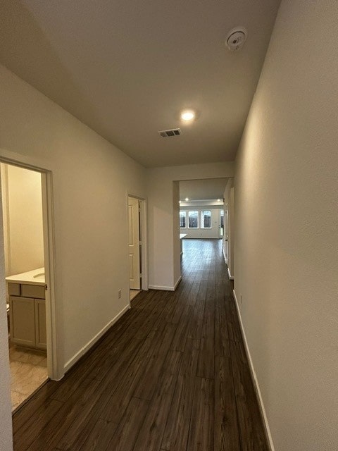 1127 Buffalo Run, Tomball, TX 77375 - hall featuring dark wood finished floors and baseboards