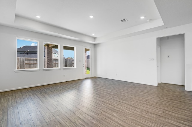 1127 Buffalo Run, Tomball, TX 77375 - unfurnished room with a tray ceiling, wood finished floors, and recessed lighting