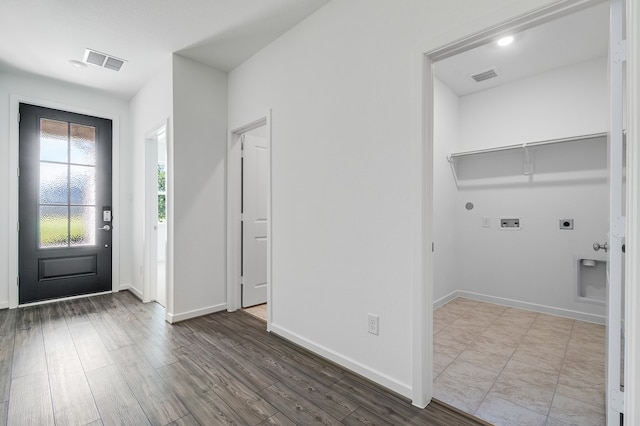 1127 Buffalo Run, Tomball, TX 77375 - laundry room with electric dryer hookup, washer hookup, gas dryer hookup, and wood finished floors