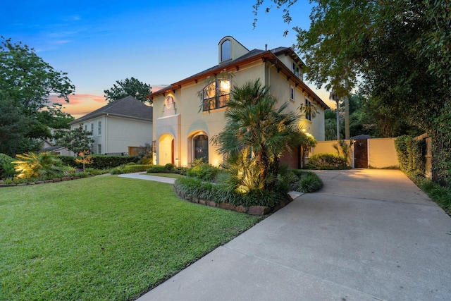 38 Hackberry Ln, Houston, TX 77027 - mediterranean / spanish-style house featuring stucco siding, driveway, a gate, and an attached garage