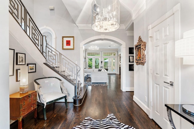 38 Hackberry Ln, Houston, TX 77027 - foyer featuring arched walkways, a chandelier, wood finished floors, crown molding, and stairway
