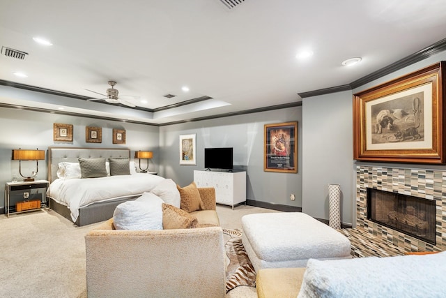 38 Hackberry Ln, Houston, TX 77027 - carpeted bedroom with ornamental molding, recessed lighting, a tile fireplace, a ceiling fan, and a raised ceiling