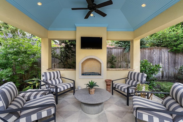 38 Hackberry Ln, Houston, TX 77027 - fenced backyard featuring an outdoor living space with a fireplace, a ceiling fan, and a patio