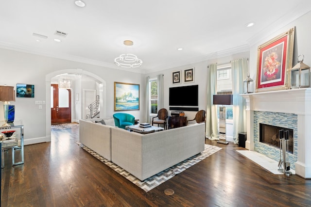 38 Hackberry Ln, Houston, TX 77027 - living room featuring arched walkways, dark wood-style floors, recessed lighting, crown molding, and a fireplace with flush hearth