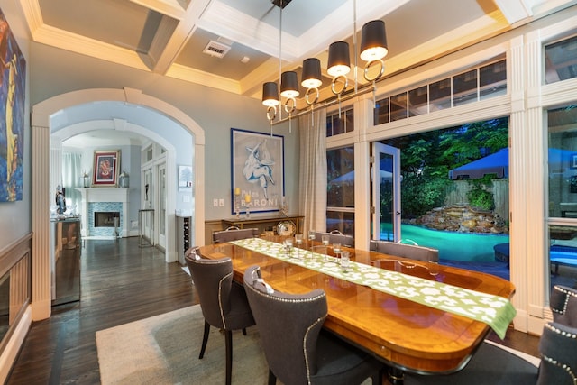 38 Hackberry Ln, Houston, TX 77027 - dining area featuring coffered ceiling, a chandelier, dark wood-type flooring, ornamental molding, and a fireplace