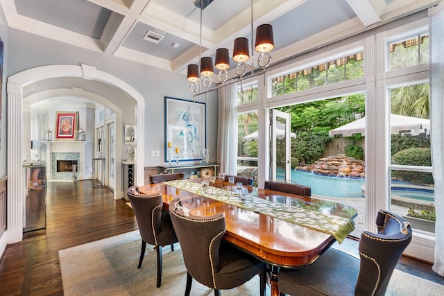 38 Hackberry Ln, Houston, TX 77027 - dining space featuring coffered ceiling, wood finished floors, beamed ceiling, a fireplace, and a chandelier