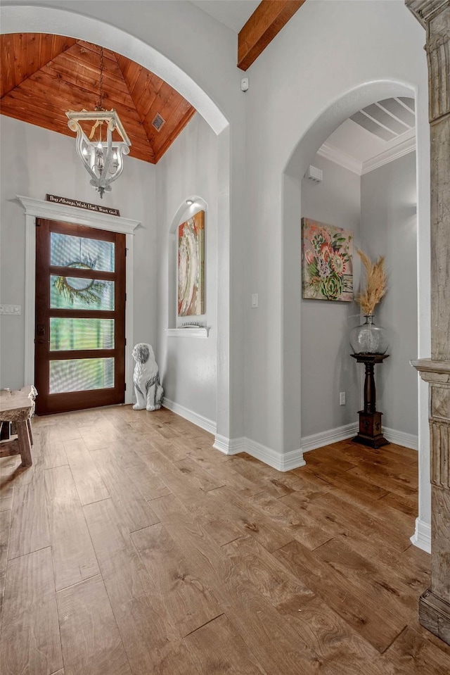 17817 Ranch House Rd, College Station, TX 77845 - entryway with vaulted ceiling, a chandelier, wood finished floors, wood ceiling, and arched walkways