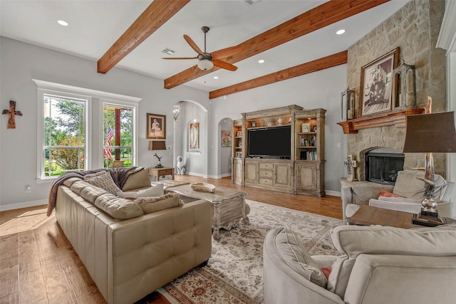 17817 Ranch House Rd, College Station, TX 77845 - living area featuring arched walkways, a ceiling fan, a fireplace, light wood-style floors, and recessed lighting