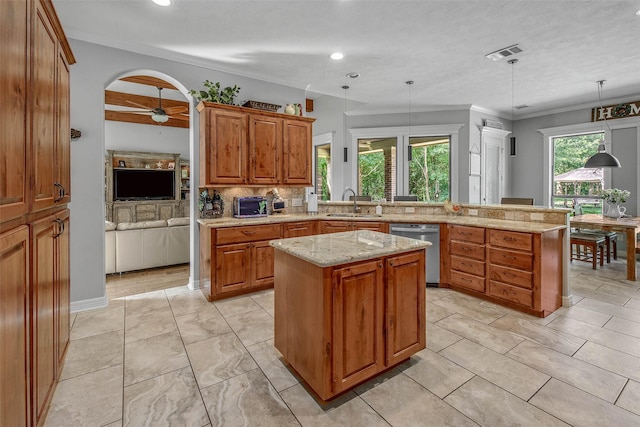 17817 Ranch House Rd, College Station, TX 77845 - kitchen with dishwasher, brown cabinetry, a peninsula, a kitchen island, and crown molding