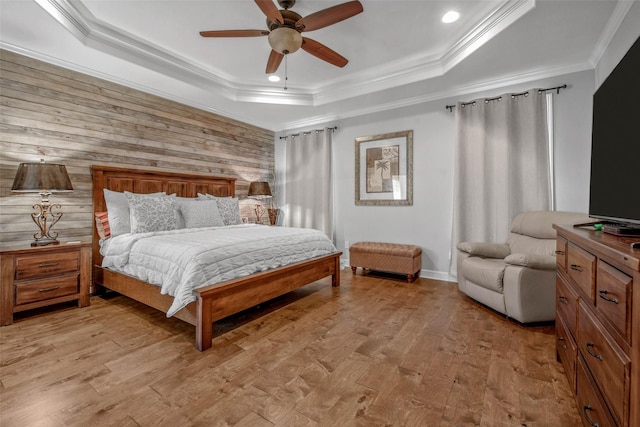 17817 Ranch House Rd, College Station, TX 77845 - bedroom with a raised ceiling, crown molding, light wood finished floors, wood walls, and ceiling fan