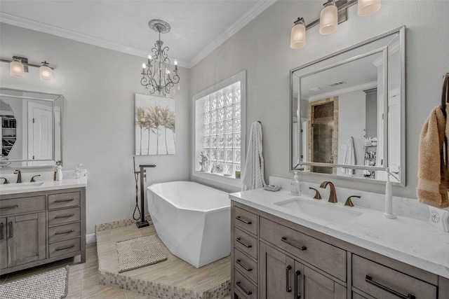 17817 Ranch House Rd, College Station, TX 77845 - bathroom with two vanities, a freestanding tub, crown molding, and a chandelier