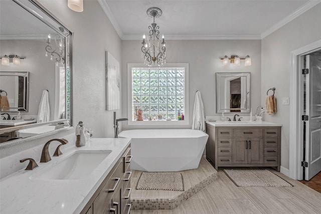 17817 Ranch House Rd, College Station, TX 77845 - bathroom featuring two vanities, a freestanding bath, a chandelier, and ornamental molding