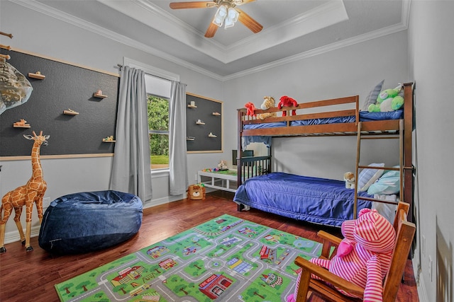 17817 Ranch House Rd, College Station, TX 77845 - bedroom featuring wood finished floors, a tray ceiling, crown molding, and ceiling fan