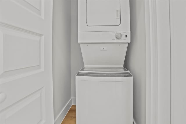 210 Galveston St, Crystal Beach, TX 77650 - washroom with stacked washer / dryer and wood finished floors