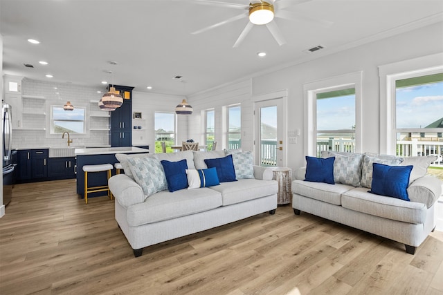 210 Galveston St, Crystal Beach, TX 77650 - living room with ceiling fan, light wood-type flooring, recessed lighting, and ornamental molding