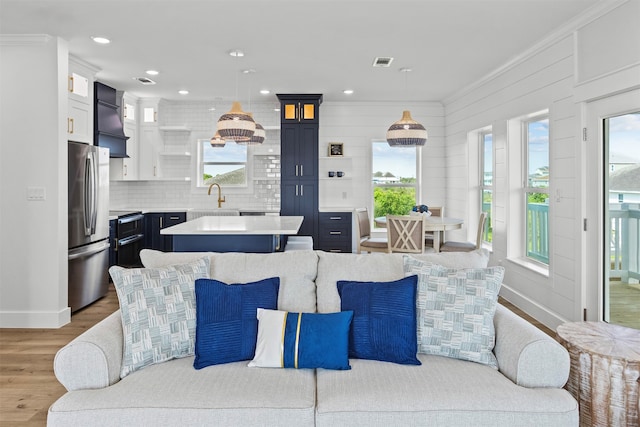 210 Galveston St, Crystal Beach, TX 77650 - living area featuring plenty of natural light, light wood-style flooring, and recessed lighting