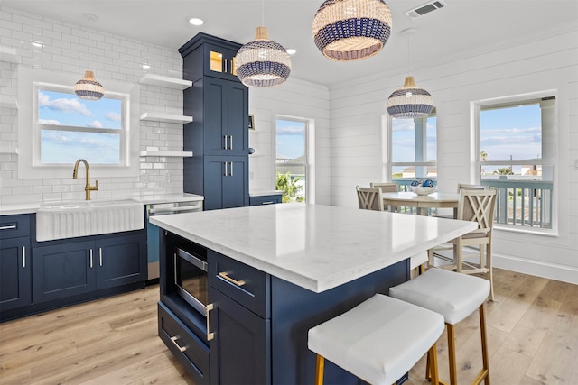 210 Galveston St, Crystal Beach, TX 77650 - kitchen featuring open shelves, blue cabinets, a kitchen breakfast bar, and recessed lighting